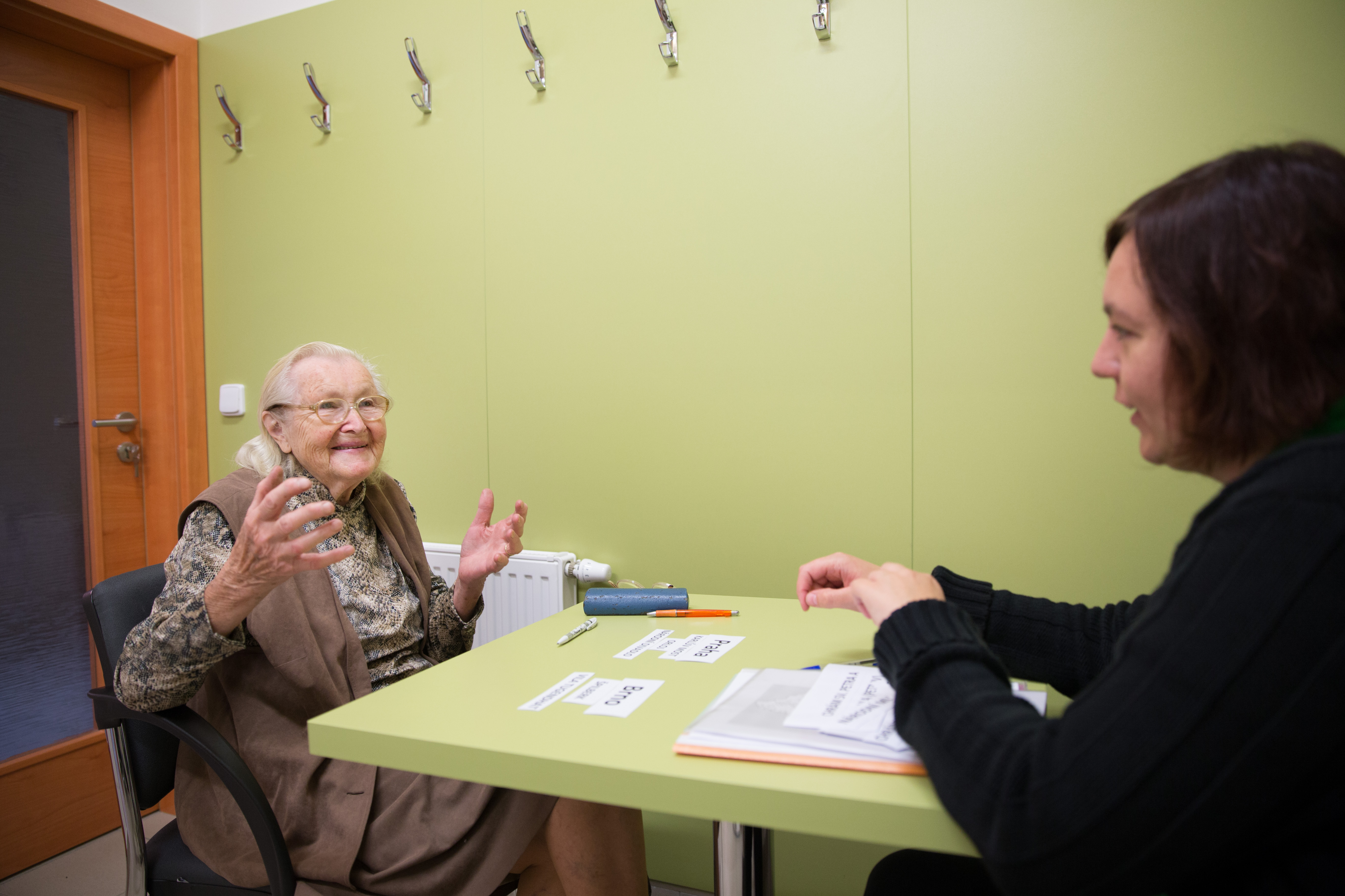 Elderly woman sitting and talking to a younger woman in care centre in Brtnice, Czech Republic. Phot. Michal Novotny