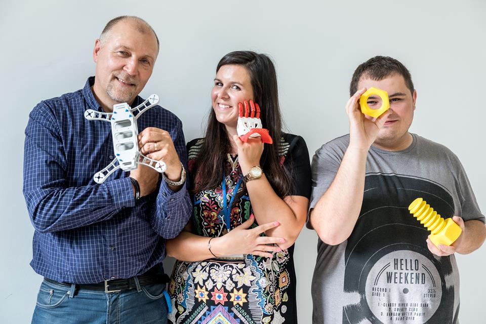 Two man and a woman with a 3D-printed objects
