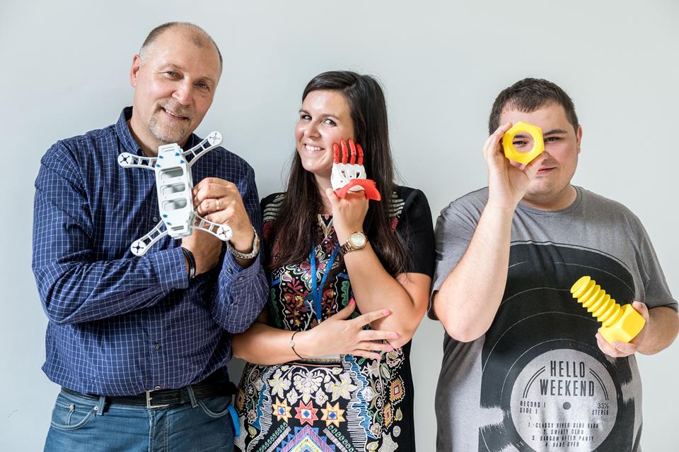 Two men and a woman with 3D printed objects